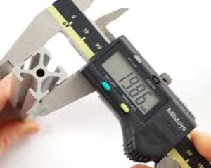 Digital caliper measuring PVC railing profile cross-section wall thickness during quality inspection Digital caliper measuring PVC railing profile cross-section wall thickness during quality inspection
