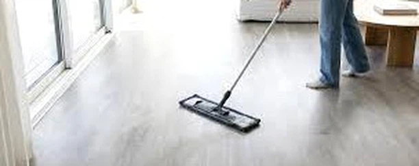 Commercial cleaning staff using microfiber flat mop on SPC stone plastic composite flooring in retail store after hours - daily maintenance routine for high-traffic waterproof vinyl plank floor requiring only neutral cleaner and damp mopping Commercial cleaning staff using microfiber flat mop on SPC stone plastic composite flooring in retail store after hours - daily maintenance routine for high-traffic waterproof vinyl plank floor requiring only neutral cleaner and damp mopping