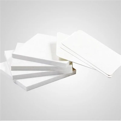Expanded PVC foam board sheet showing smooth matte surface skin and closed-cell foam core cross-section characteristic of Celuka extrusion process Expanded PVC foam board sheet showing smooth matte surface skin and closed-cell foam core cross-section characteristic of Celuka extrusion process