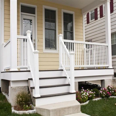 White PVC vinyl deck railing system with aluminum-reinforced posts and square balusters installed on elevated residential porch - weatherproof guardrail with co-extruded UV capstock finish maintaining color stability under direct sunlight exposure White PVC vinyl deck railing system with aluminum-reinforced posts and square balusters installed on elevated residential porch - weatherproof guardrail with co-extruded UV capstock finish maintaining color stability under direct sunlight exposure
